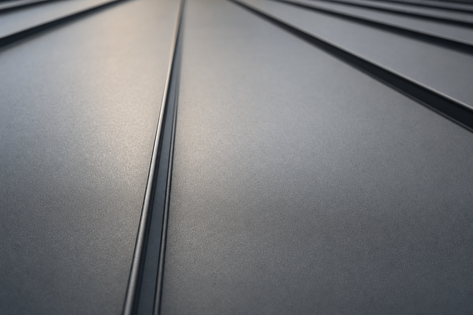 Close-up of standing seam metal panel seams, charcoal